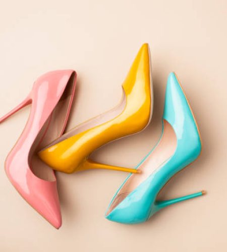 Bright colored women's shoes on a solid background. Copy space text.